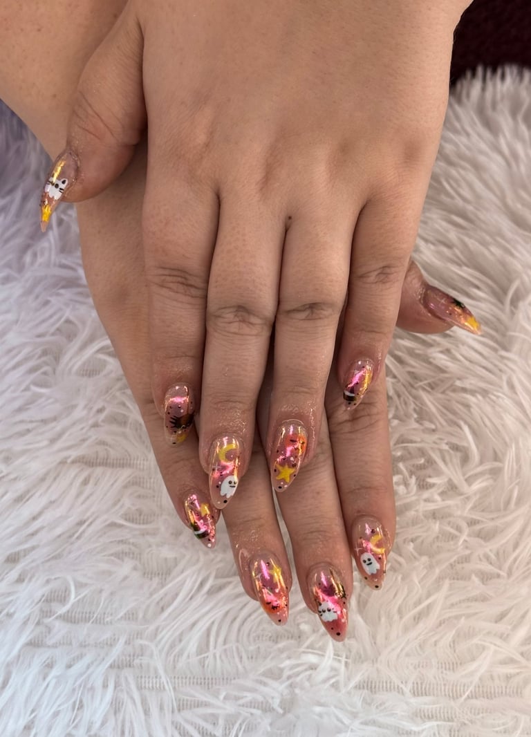 Close-up of manicured nails with red, pink, and gold leaf nail art design on textured background