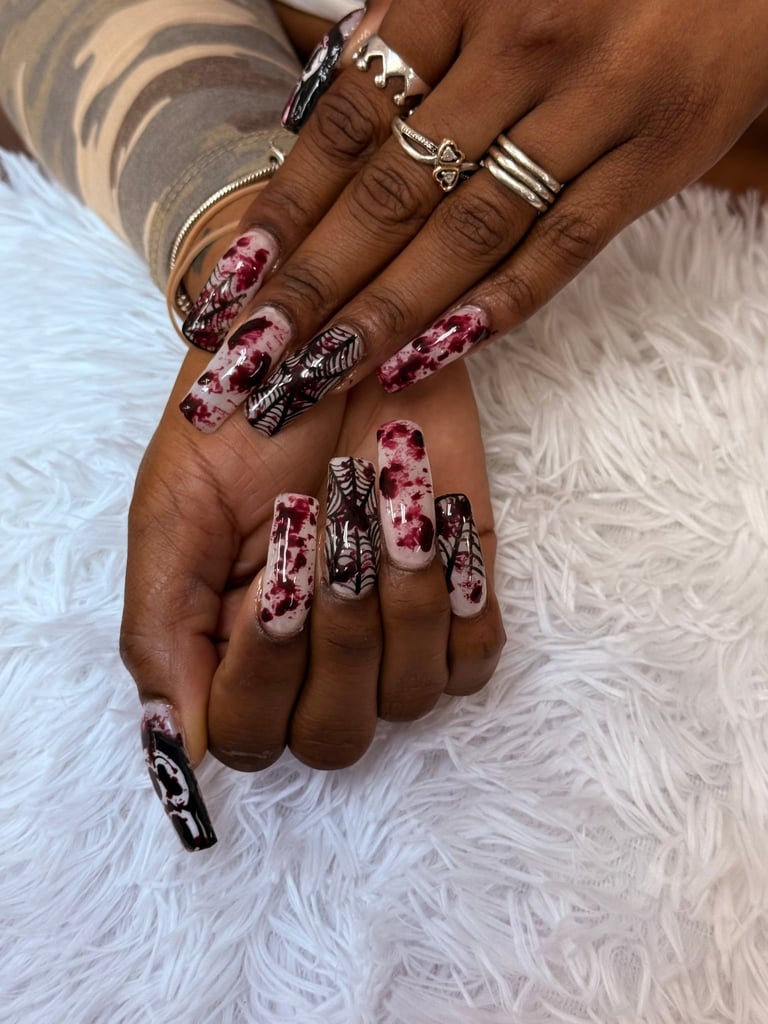 Two hands displaying long acrylic nails with pink and black marble design and silver jewelry, positioned on white fur